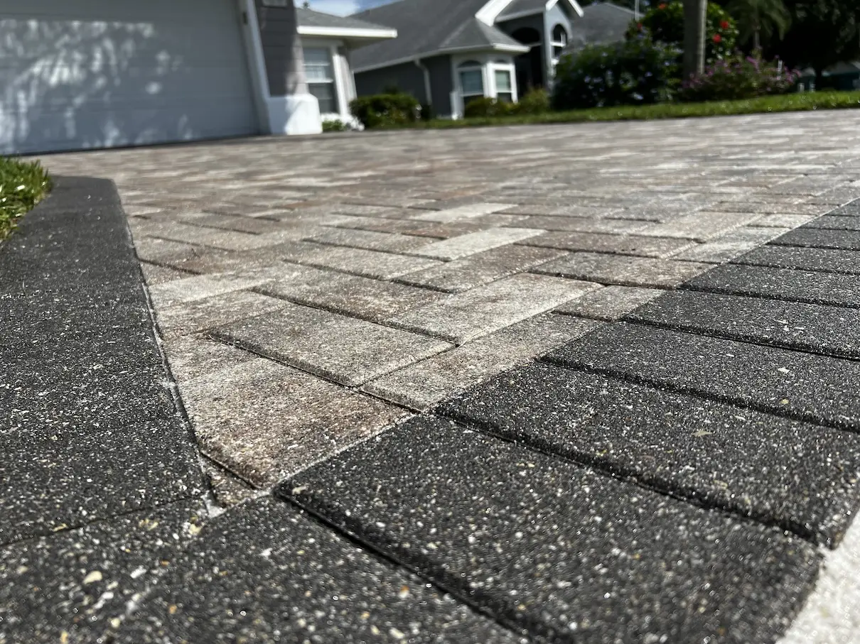 Detailed view of a sealed residential paver driveway